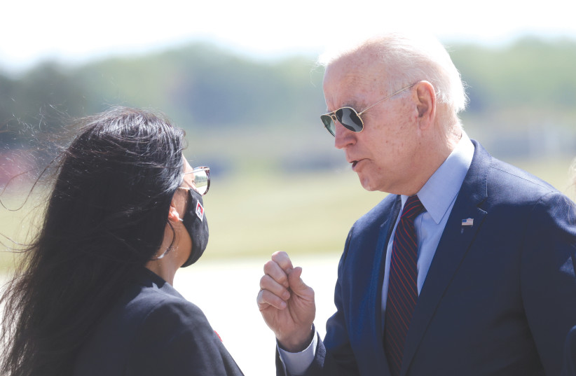  US PRESIDENT Joe Biden speaks with Rep. Rashida Tlaib (D-Michigan) at a Detroit airport, in May of last year. That same month, while Israel was being bombarded by Hamas rockets, Biden strongly praised Tlaib – who opposes Israel’s very existence, says the writer. (photo credit: Leah Mills/Reuters)