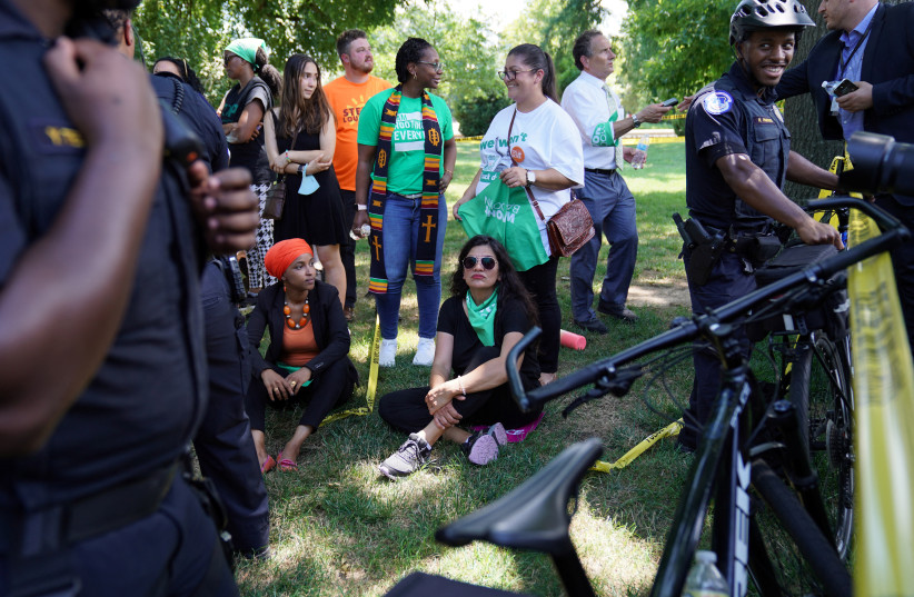  Representatives Ilhan Omar (D-MN) and Rashida Tlaib (D-MI) are detained for their part in an abortion rights protest outside of the US Supreme Court in Washington, DC, US, July 19, 2022.  (photo credit: REUTERS/SARAH SILBIGER)