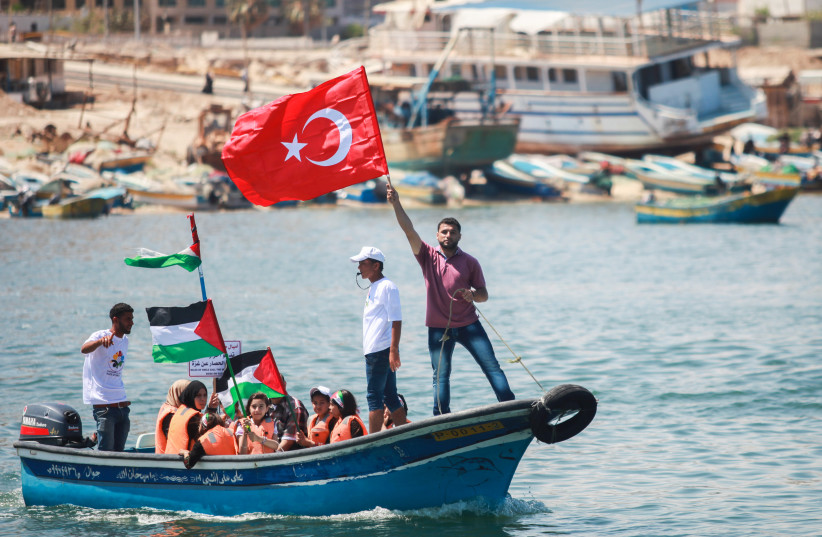  TAKING TO the water with Palestinian and Turkish flags during a rally marking the fifth anniversary of the ‘Mavi Marmara,’ at Gaza City Port, May 31, 2015.  (credit: Aaed Tayeh/Flash90)