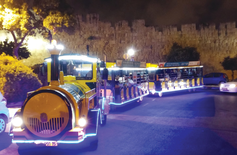  CHUGGING PAST the Old City walls on a nighttime ride. (credit: Old City Train)