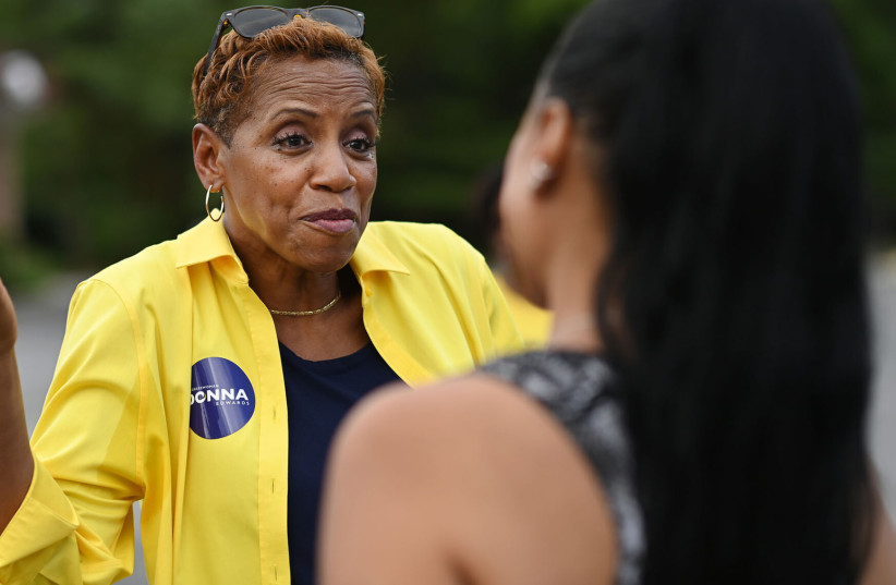  Donna Edwards greets a voter at Breath of Life Seventh-day Adventist Church in Fort Washington, Md., July 19, 2022.  (photo credit: MATT MCCLAIN/THE WASHINGTON POST VIA GETTY IMAGES/JTA)