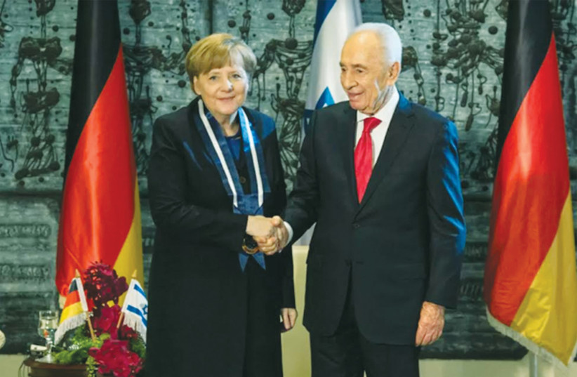  IN FEBRUARY 2014, President Shimon Peres awards the Medal of Distinction to German Chancellor Angela Merkel.  (photo credit: GPO)