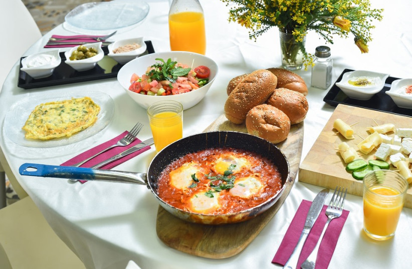 Breakfast was ‘modest,’ with only several types of cheeses, fresh salad, eggs, tuna, cut vegetables, pickled cucumbers and olives, yogurt, cereal, breads and juices. (credit: GILAD HAR SHELEG)