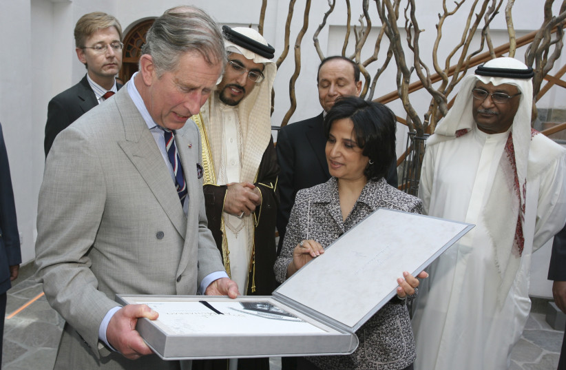  Britain's Prince Charles receives a book from Shaikha Mai bint Mohammed al Khalifa, President of Sheikh Ebrahim Centre at Abdulla Zayed House in Manama February 26, 2007 (photo credit: REUTERS/HAMAD MOHAMMED)