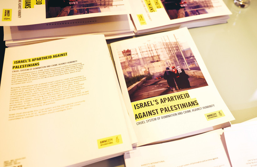  COPIES OF Amnesty International’s report titled ‘Israel’s apartheid against Palestinians’ are placed on display at a press conference at a hotel in east Jerusalem, earlier this year (photo credit: REUTERS)