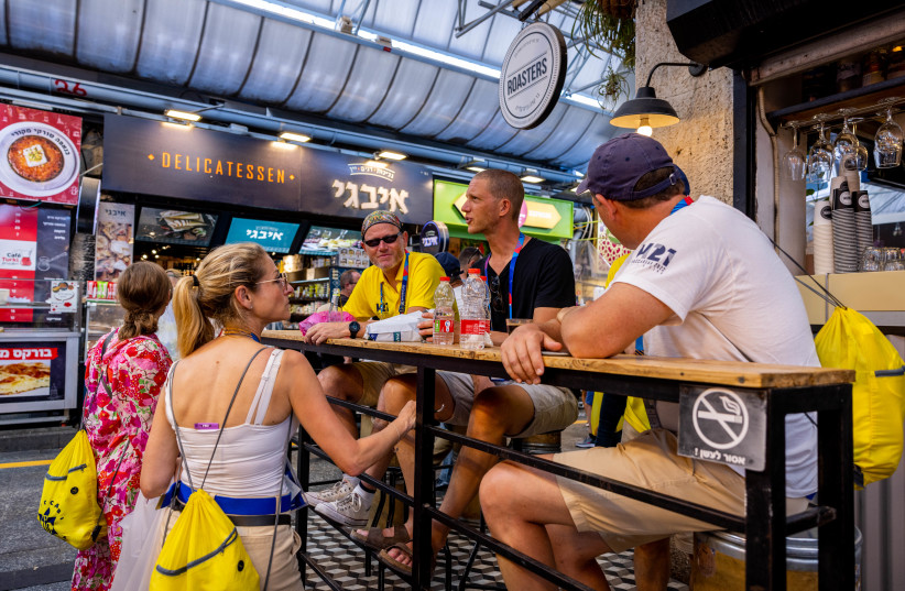  People enjoy at the Mahane Yehuda market in Jerusalem, July 21, 2022. (credit: NATI SHOHAT/FLASH90)