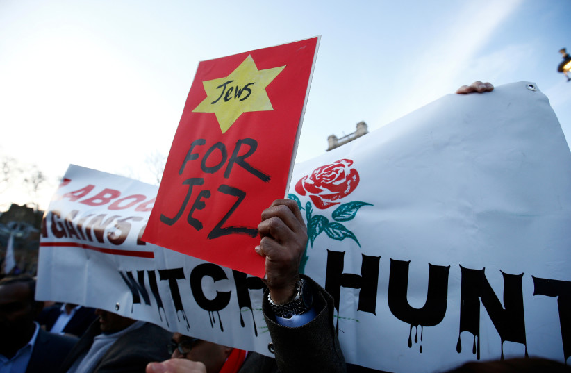  Supporters of Britain's opposition Labour Party attend a demonstration organised by the British Board of Jewish Deputies for those who oppose anti-Semitism, in Parliament Square in London, Britain, March 26, 2018.  (credit: REUTERS/HENRY NICHOLLS)