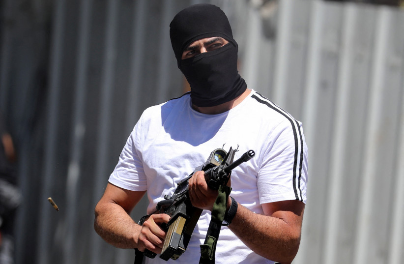  A Palestinian militant takes part in the funeral of two Palestinian gunmen who were killed by IDF in a gun battle during a raid, in Nablus in the West Bank July 24, 2022. (credit: REUTERS/RANEEN SAWAFTA)