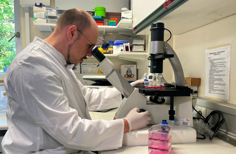 Head of the Institute of Microbiology of the German Armed Forces Roman Woelfel works in his laboraty in Munich, May 20, 2022, after Germany has detected its first case of monkeypox. (photo credit: REUTERS/CHRISTINE UYANIK)