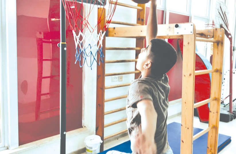  A YOUTH goes to the hoop at a previous ALYN Therapeutic Sports Day.  (photo credit: ALYN HOSPITAL)