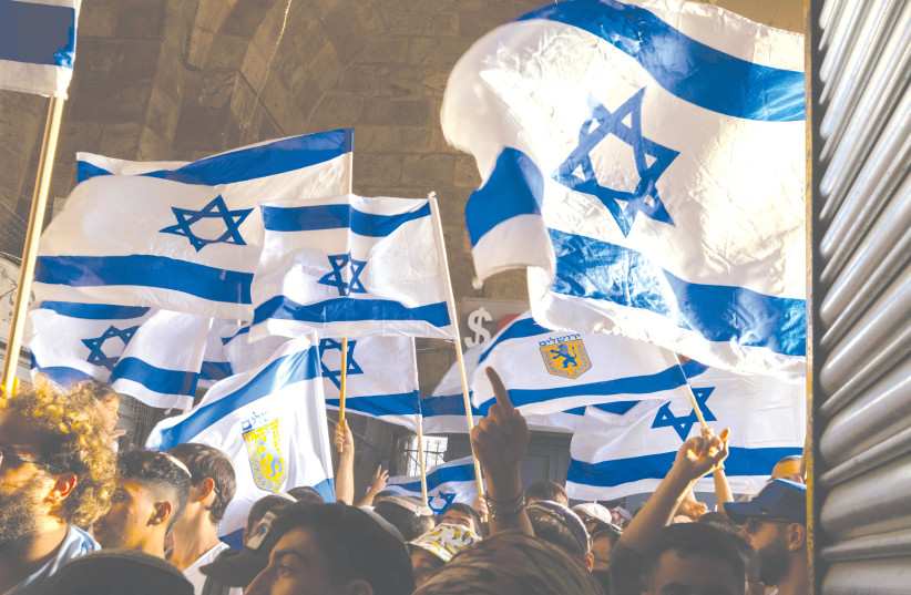  A FLAG march takes place through the Old City on Jerusalem Day, in May. Israel will become a bi-national state and its Jewish expressions, including the national flag, will lose their status and their meaning, the writer warns.  (photo credit: OLIVIER FITOUSSI/FLASH90)