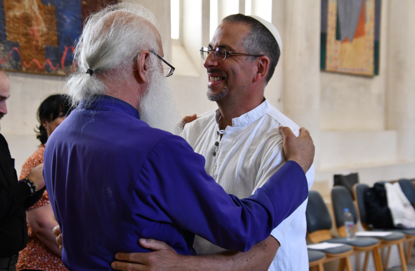 Rabbi Golan Ben-Chorin and Bishop Malkhaz Songulashvili embrace in the Peace Cathedral.  (credit: NANO SARALISHVILI)