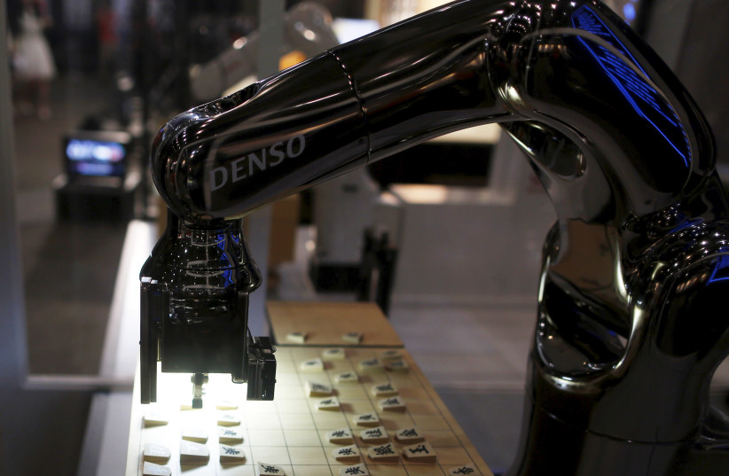 Denso Corp's robot arm ''Denoute-san'' plays Japanese chess, also known as Shogi, at a booth during Niconico Chokaigi 2015 in Makuhari, east of Tokyo, Japan, April 26, 2015. (credit: REUTERS/YUYA SHINO)