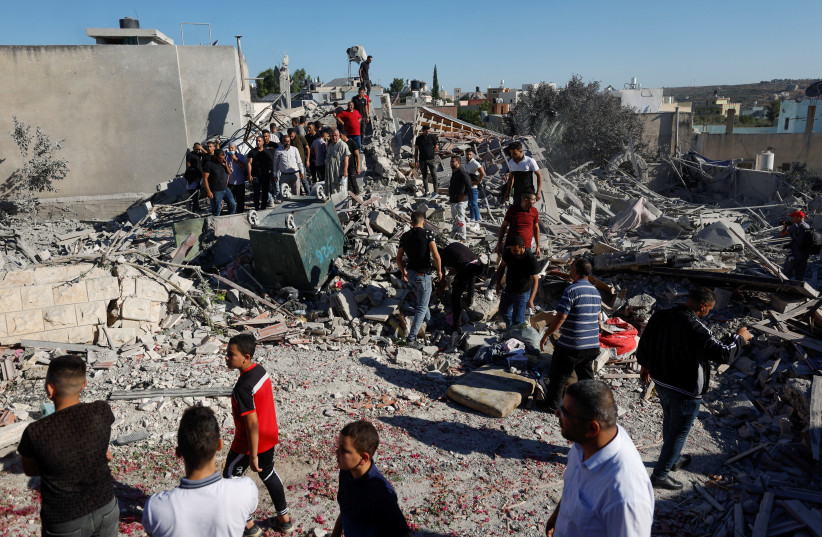  Israeli Defense Forces demolish the home of Palestinian terrorist who carried out an attack in Ariel in April, July 26, 2022 (photo credit: REUTERS/MOHAMAD TOROKMAN)