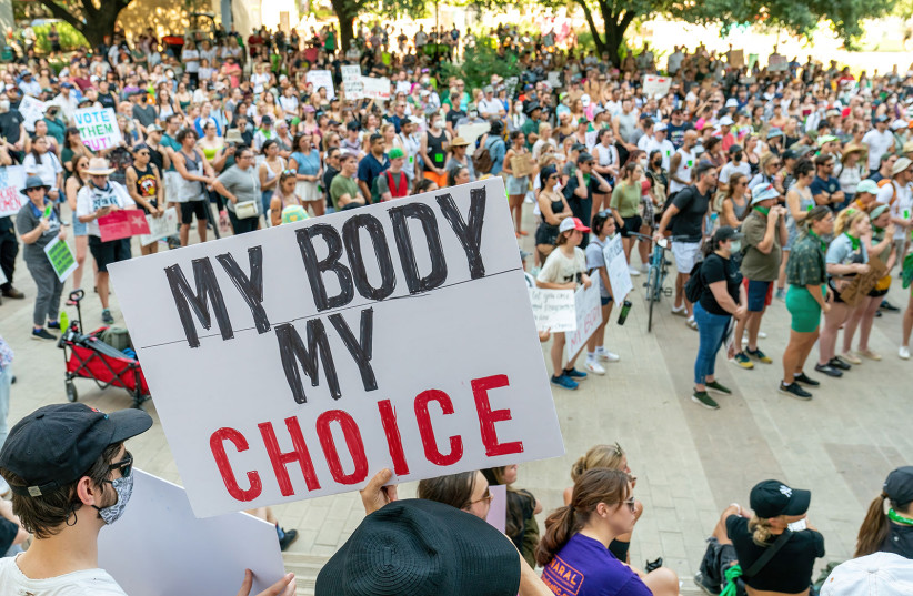  Abortion rights activists hold a "My Body My Choice" sign as they protest at the Federal Courthouse Plaza, after the overturning of Roe Vs. Wade by the US Supreme Court, in Austin, Texas, on June 24, 2022. (photo credit: SUZANNE CORDEIRO/AFP VIA GETTY IMAGES/TNS)