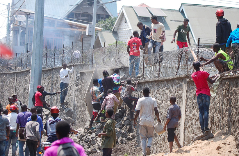  Congolese protesters scale the perimeter wall of the compound of United Nations peacekeeping force's warehouse in Goma in the North Kivu province of the Democratic Republic of Congo July 26, 2022. (credit: REUTERS/Esdras Tsongo)