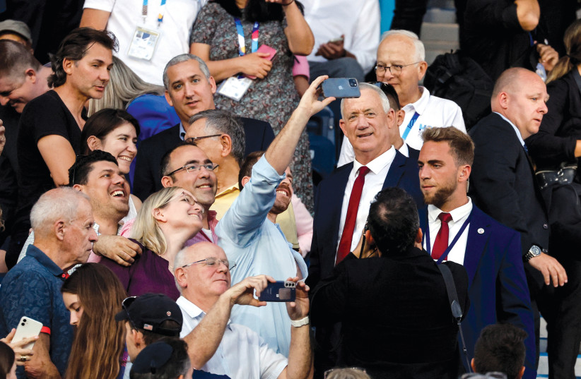  A fan takes a selfie with Defense Minister Benny Gantz at the opening ceremony of the Maccabiah in Jerusalem on July 14. (credit: AMMAR AWAD/REUTERS)