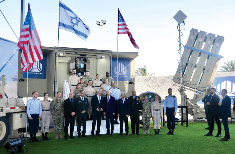  US President Joe Biden poses for a photograph with US and Israeli officials as he is given a tour of Israel’s Iron Dome missile defense system at Ben-Gurion Airport after his arrival on July 13.  (photo credit: MARC ISRAEL SELLEM)