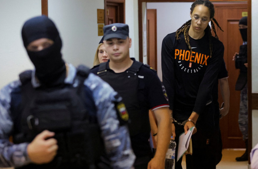 US basketball player Brittney Griner, who was detained at Moscow's Sheremetyevo airport and later charged with illegal possession of cannabis, is escorted before a court hearing in Khimki outside Moscow, Russia July 27, 2022. (photo credit: REUTERS/Evgenia Novozhenina/Pool)