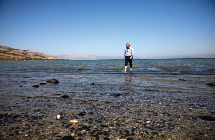  A NEW chapter for Yuval Steinitz: Walking in Lake Kinneret, 2018.  (photo credit: RONEN ZVULUN/REUTERS)