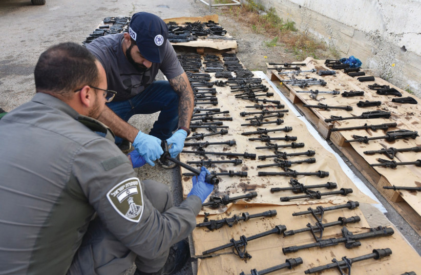  ISRAEL POLICE inspect seized weapon parts as part of action against weapons offenses in northern Arab communities. (photo credit: ISRAEL POLICE)