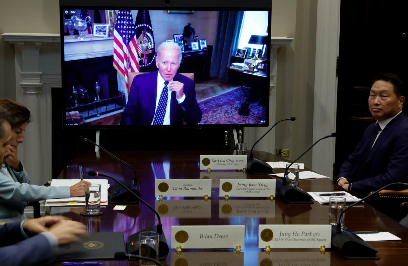 US President Joe Biden appears on screen to meet virtually with a delegation from SK Group led by Chairman Chey Tae-won, from the Roosevelt Room at the White House in Washington, US July 26, 2022. (credit: REUTERS/JONATHAN ERNST)