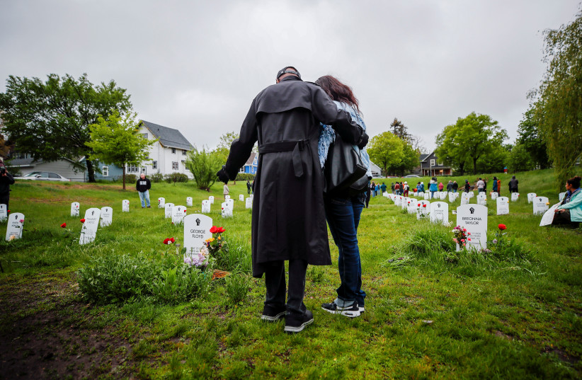 Members of George Floyd's family look at his headstone at the Say Their Names memorial as part of a march and vigil on the second anniversary of the death of George Floyd, May 25, 2022. (credit: ERIC MILLER/REUTERS)