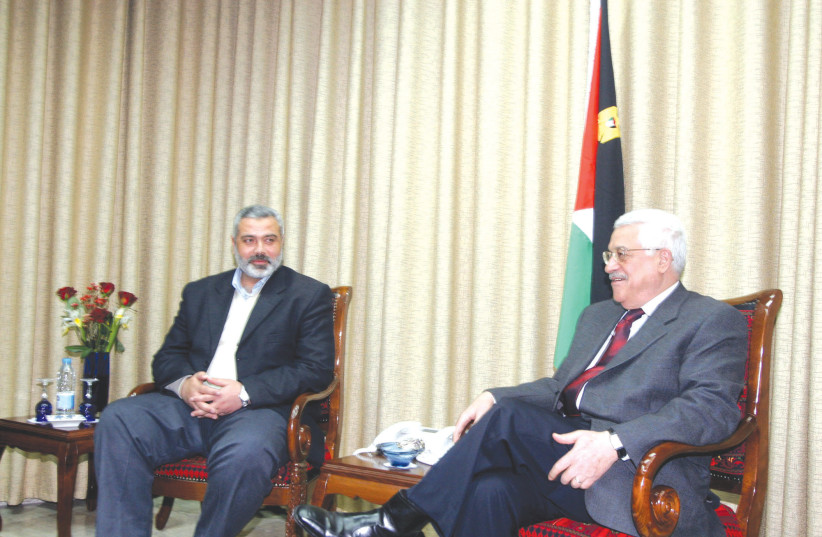 PALESTINIAN AUTHORITY President Mahmoud Abbas meets with Hamas leader Ismail Haniyeh in Gaza City, in 2006. The Palestinian side faces a divided political house between the West Bank and Gaza, where both governments have little legitimacy from their own street, says the writer (photo credit: Ahmad Khateib/Flash90)