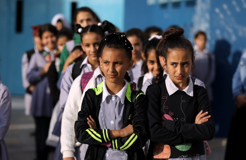  Palestinian schoolchildren stand in a line at a school run by UNRWA (United Nations Relief and Works Agency) in the Shuafat refugee camp in east Jerusalem October 10, 2018 (photo credit: AMMAR AWAD/REUTERS)