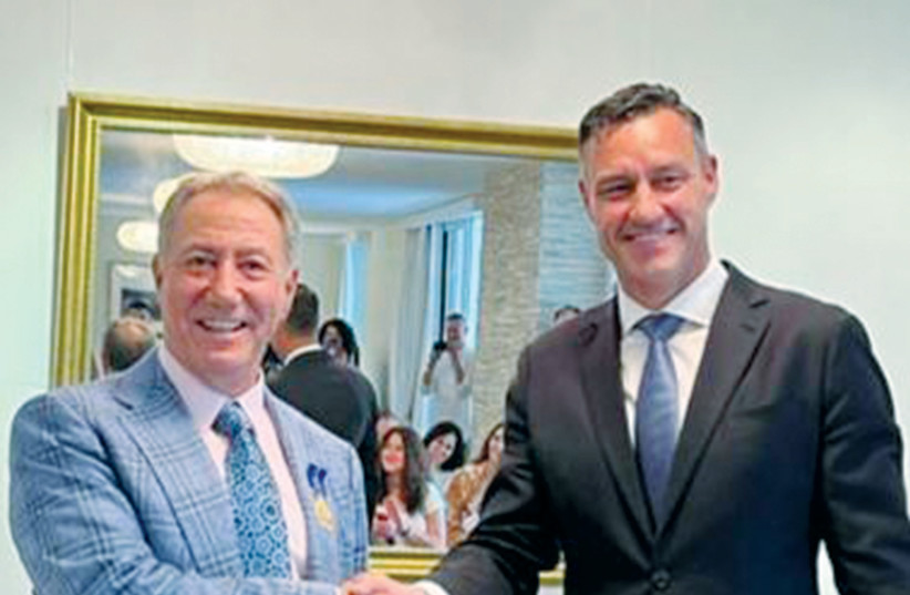  DANNY HAKIM (left) being congratulated by Australian Ambassador Paul Griffiths. (credit: JORDAN POLEVOY)