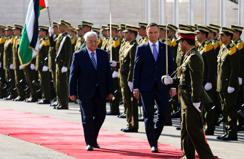 Palestinian President Mahmoud Abbas and Polish President Andrzej Duda review the honour guard in the West Bank town of Bethlehem January 18, 2017.  (photo credit: REUTERS/MUSSA QAWASMA)