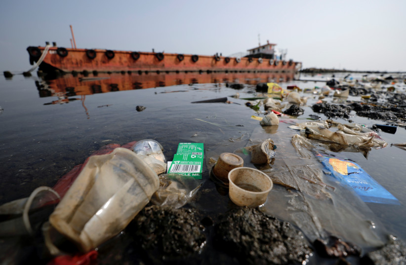 Garbage, most of it plastics and domestic waste, is seen along the shore of Jakarta, Indonesia, June 8, 2021. (photo credit: REUTERS/WILLY KURNIAWAN)