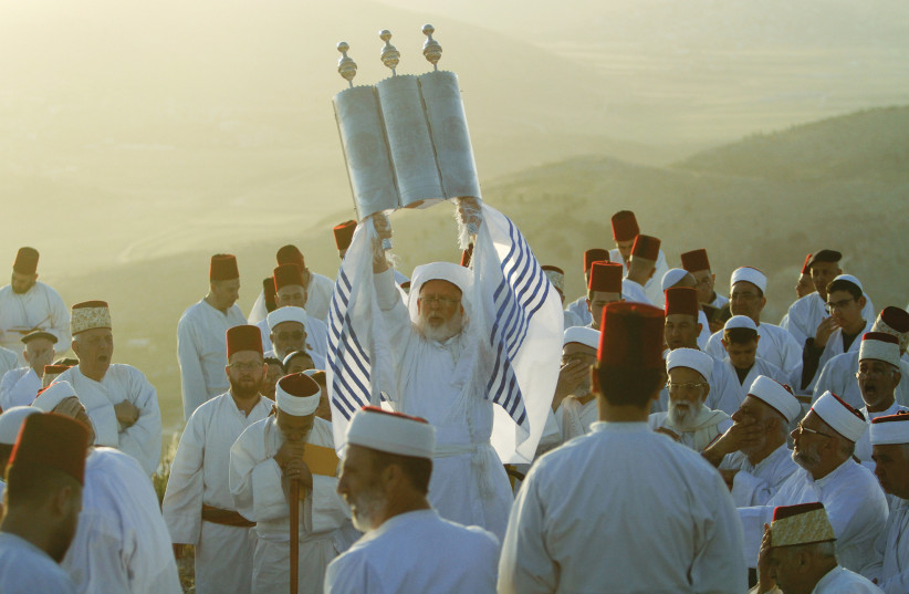  MEMBERS OF the Samaritan community pray atop Mount Gerizim at sunrise during a service marking the end of Passover. (photo credit: NASSER ISHTAYEH/FLASH90)