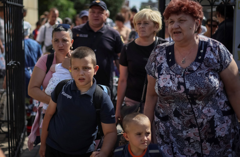 People board a train to Dnipro and Lviv during an evacuation effort from war-affected areas of eastern Ukraine, amid Russia's invasion of the country, in Pokrovsk, Donetsk region, Ukraine, July 20, 2022. (credit: REUTERS/GLEB GARANICH)