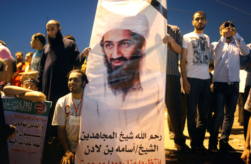  Demonstrators carry a poster of Osama Bin Laden during a protest condemning a U.S. produced movie insulting Islam's Prophet Mohammad in Tahrir Square September 14, 2012 (credit: REUTERS/ASMAA WAGUIH)