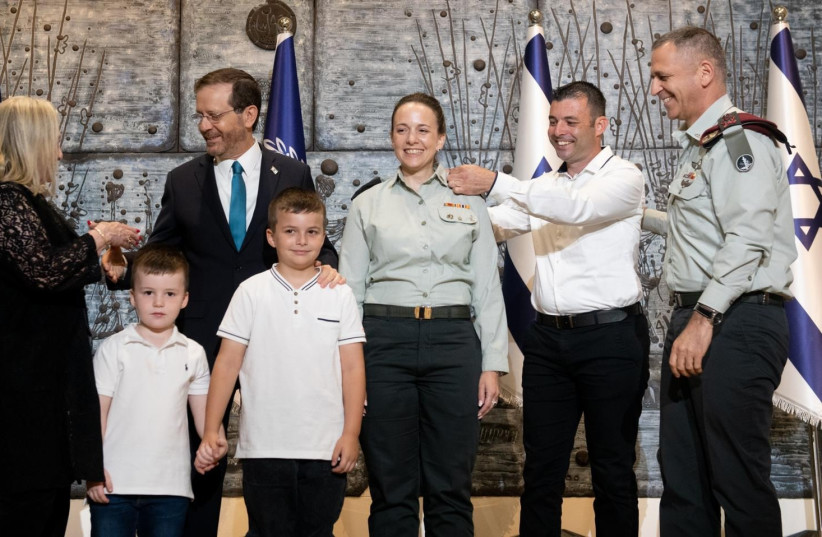 President Isaac Herzog and Lt.-Gen Aviv Kohavi pinning the insignia of Brig.-Gen. to Naama Rosen-Greenberg shoulder, July 21, 2022. (credit: IDF SPOKESPERSON UNIT)