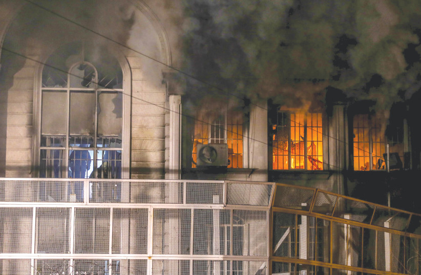  FLAMES AND smoke rise from the Saudi Embassy in Tehran in January 2016, when Iranian protesters stormed the embassy following the reported Saudi execution of a prominent Shi’ite cleric (photo credit: ISNA/REUTERS)
