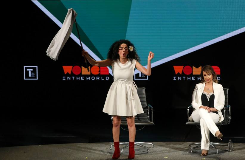 Masih Alinejad, Iranian journalist and women's rights activist, speaks on stage at the Women In The World Summit in New York, U.S, April 12, 2019.  (photo credit: REUTERS/BRENDAN MCDERMID)