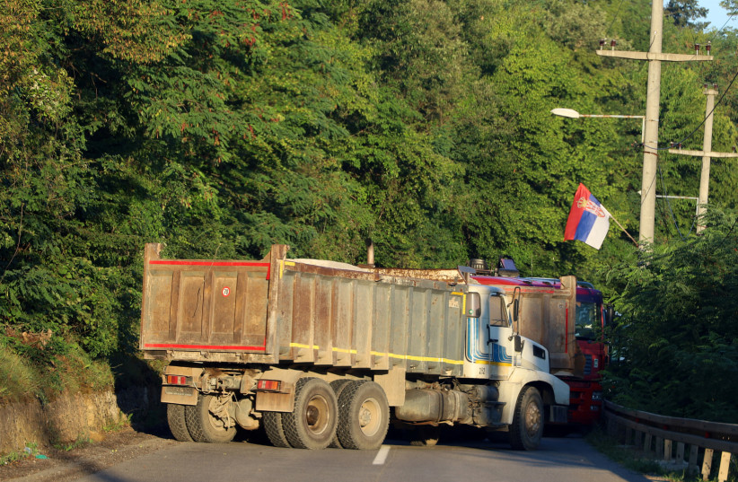  A Serbian flag is seen as trucks block a road in Zupce, Kosovo August 1, 2022. (credit: REUTERS/FATOS BYTYCI)