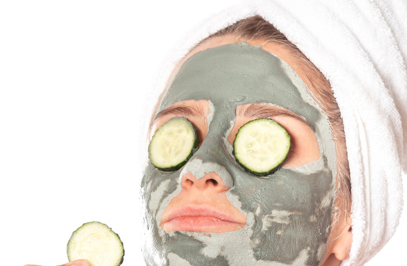  Illustrative image of a girl in a facemask eating a cucumber, October  (photo credit: Marco Verch Professional Photographer/Flickr)