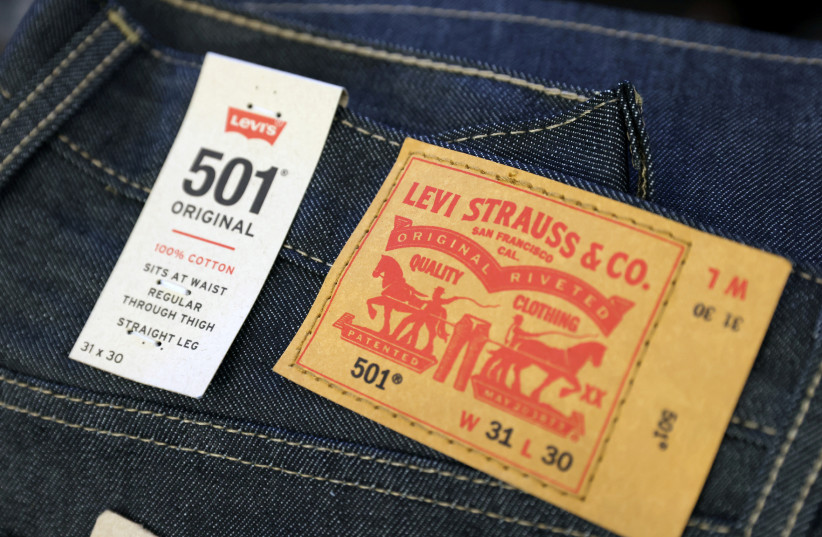  The Levi Strauss & Co. label is seen on jeans in a store at the Woodbury Common Premium Outlets in Central Valley, New York, US, February 15, 2022 (credit: REUTERS/ANDREW KELLY/FILE PHOTO)