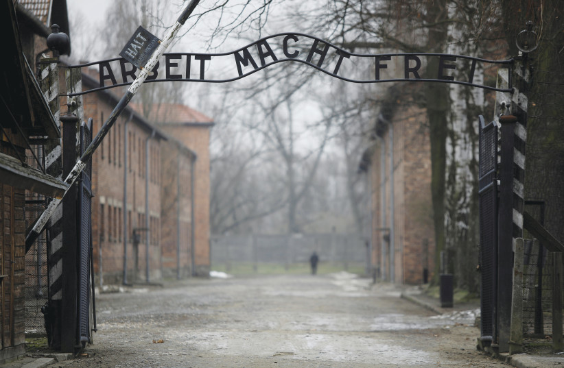  THE GATE to Auschwitz, photographed in January 2021, 76 years after the camp’s liberation: There are still countless Jews who say about the Shoah, ‘If this could happen, how can anyone still believe in God?’ (photo credit: KACPER PEMPEL/REUTERS)