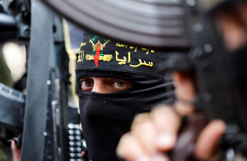  Palestinian Islamic Jihad militants take part in a rally to celebrate the shooting attacks in Israel, in Khan Younis, in the southern Gaza Strip April 8, 2022. (credit: REUTERS/IBRAHEEM ABU MUSTAFA)