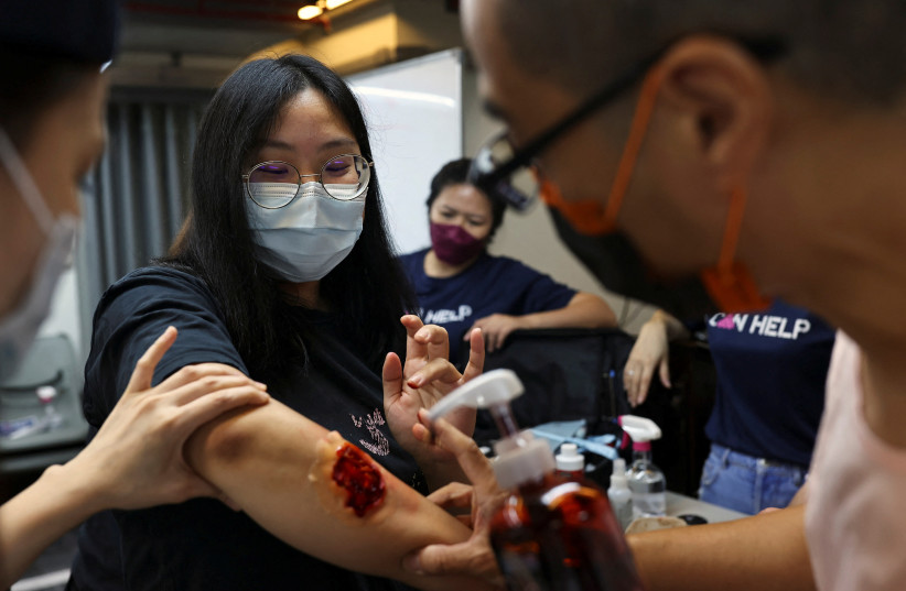  Volunteers place a fake wound on a participant during a first aid training in Taipei, Taiwan, July 23, 2022. (credit: REUTERS/ANN WANG)
