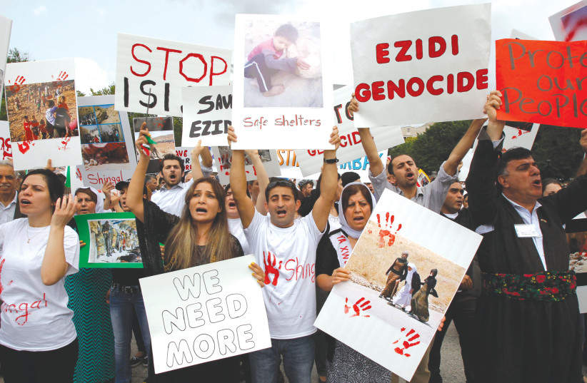  KURDISH ACTIVISTS rally in Washington in defense of the Yezidi people living in Sinjar, in August 2014. (photo credit: YURI GRIPAS/REUTERS)