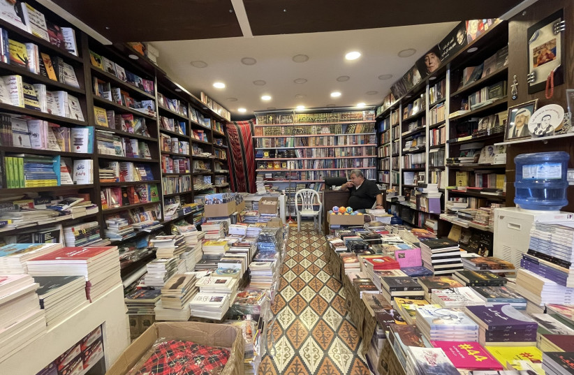 Khalid Khandakji waits for customers at The Popular Bookstore, in the Old City of Nablus, West Bank, July 27, 2022 (credit: MOHAMMAD AL-KASSIM/THE MEDIA LINE)