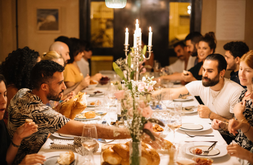  “Young Tel Avivians  at MINYAN. Participants from diverse backgrounds are invited to celebrate Shabbat with 10 total strangers in an attempt to form a new kind of Jewish community" (photo credit: MATAN PORTNOY)