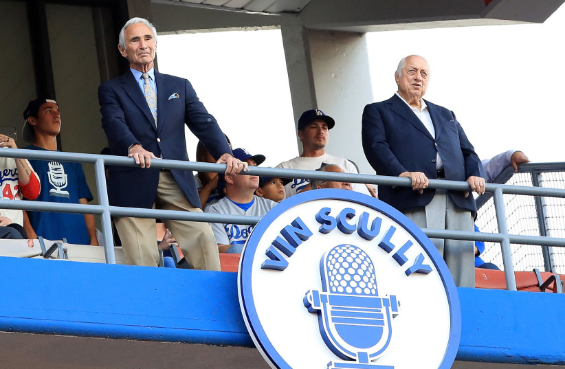Sandy Koufax and Tommy Lasorda stand next to the Vin Scully plaque in the left field grandstands after his induction into the Los Angeles Dodgers Ring of Honor at Dodger Stadium on May 3, 2017 in Los Angeles, California. (photo credit: HARRY HOW/GETTY IMAGES)