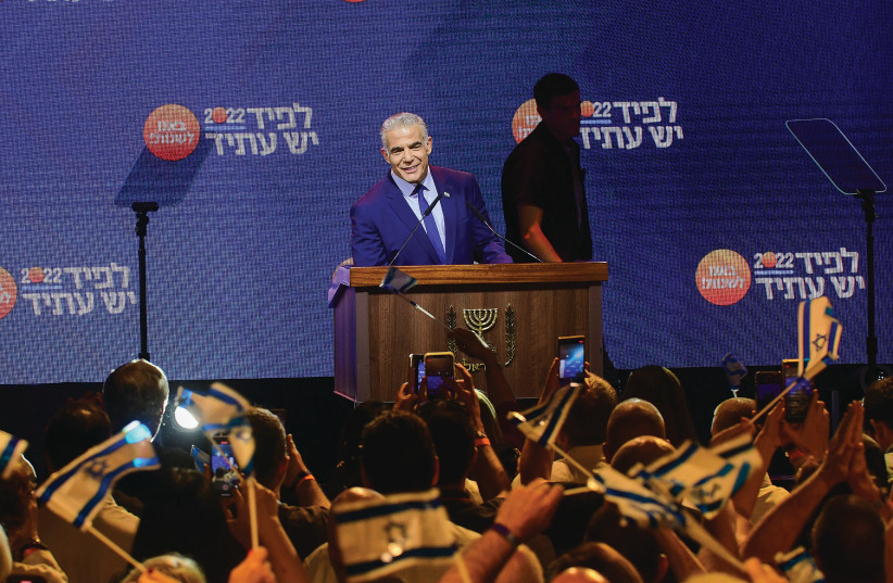  PRIME MINISTER and Yesh Atid chairman Yair Lapid speaks to party members during Wednesday night’s conference in Tel Aviv.  (photo credit: AVSHALOM SASSONI/FLASH90)