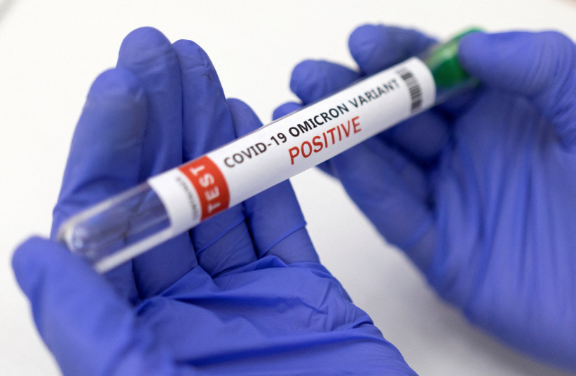  Test tube labelled "COVID-19 Omicron variant test positive" is seen in this illustration picture taken January 15, 2022. (photo credit: REUTERS/DADO RUVIC/FILE PHOTO)